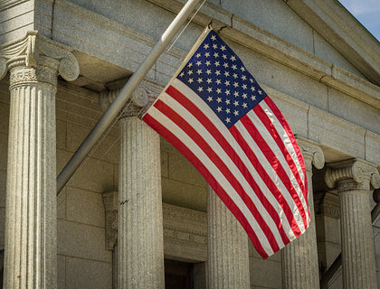 Close-up of American flag at a courthouse.