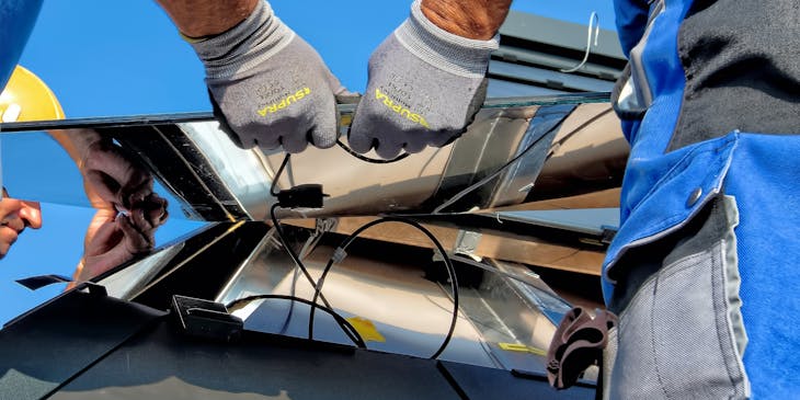 Men installing a solar panel.