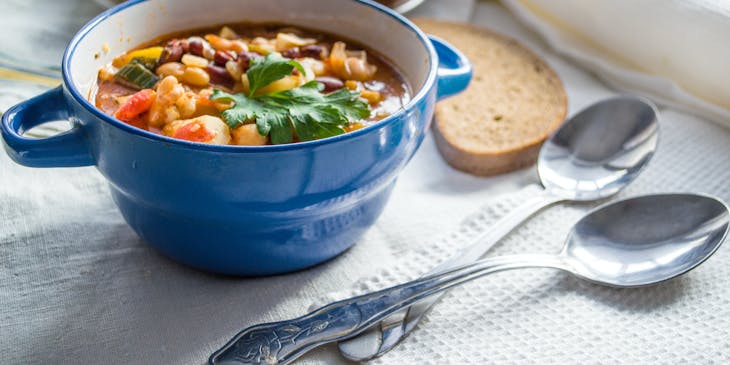 bowl of soup with silver spoons