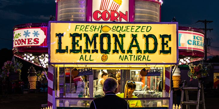Person with an instrument buying lemonade.