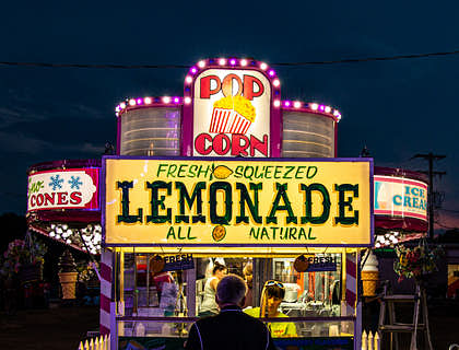 Person with an instrument buying lemonade.
