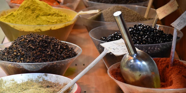 An assortment of dried spices on sale at a spice shop.