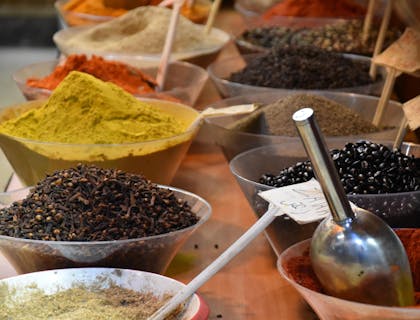 An assortment of dried spices on sale at a spice shop.