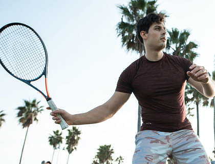 An athlete playing tennis at a sports camp.