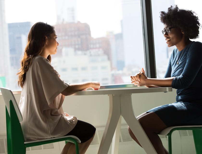 Two women having a meeting at a staffing agency.