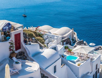 A stucco plastered buildings overlooking the ocean.