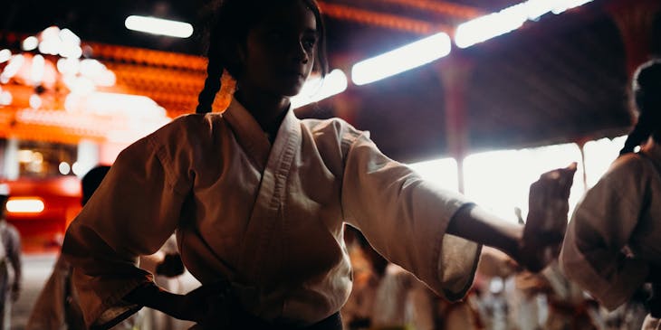 Girl in white suit at martial arts training.