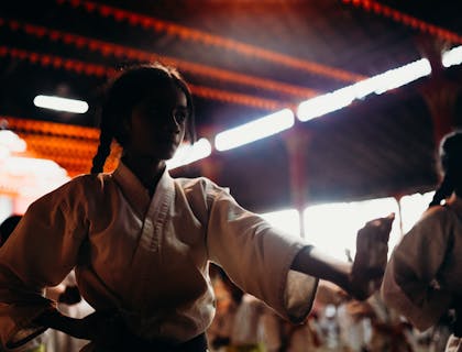 Girl in white suit at martial arts training.