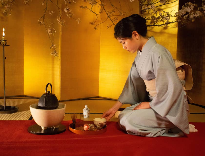 An Asian women completing a tea ceremony in a tea house.