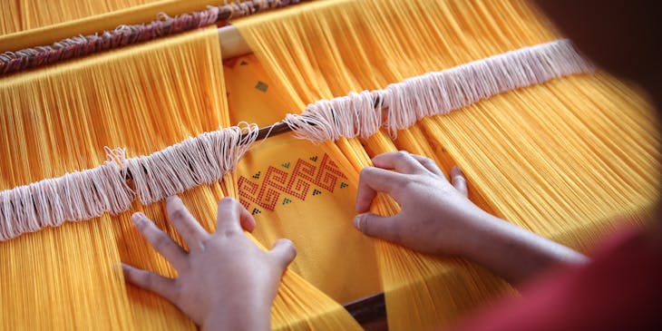 person browsing through yellow textiles