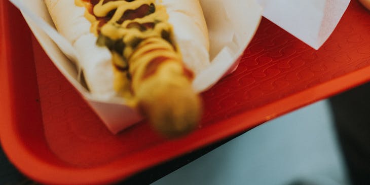 Two hot dogs with US flag toothpicks at a traditional american restaurant.