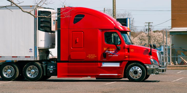 Red and white truck at a transportation business.