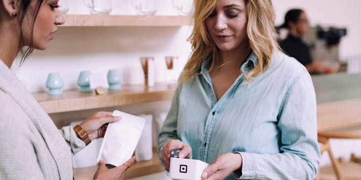 A customer paying with her credit card at a trustworthy business.