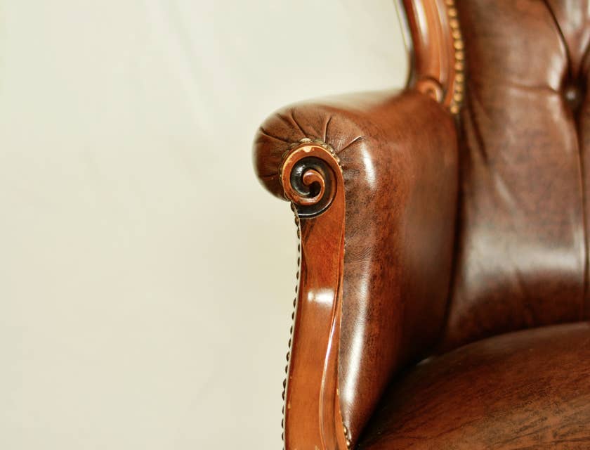 Antique armchair with brown leather upholstery