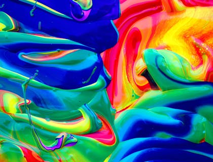 Vibrant paint colors mixed together.