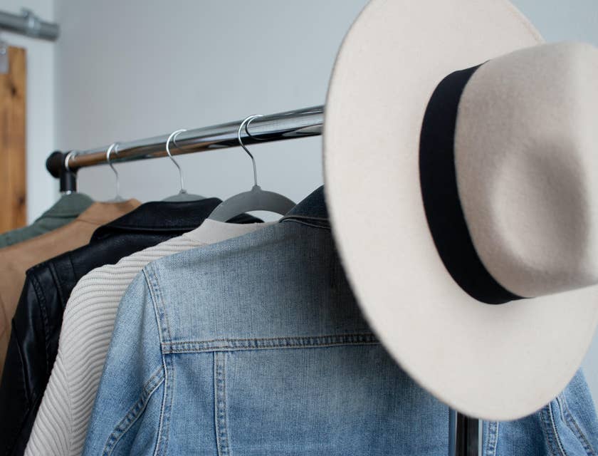 Una boutique vintage con un sombrero de vaquero sobre un aparador de chaquetas de mezclilla.