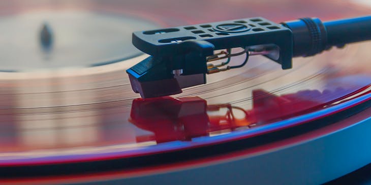 Close up of a needle on a vinyl record.