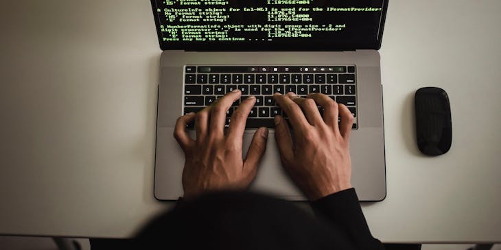 A person working remotely on their laptop for a virtual business.