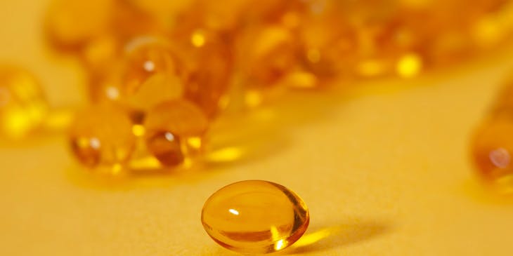 Yellow vitamins on a yellow surface.