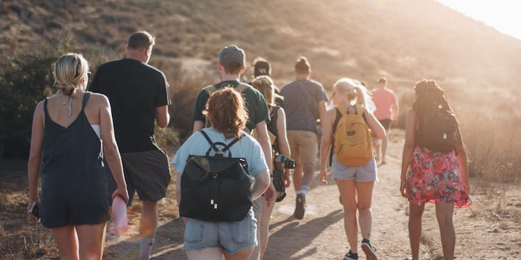 group of people on a walking tour with their backs turned to the camera
