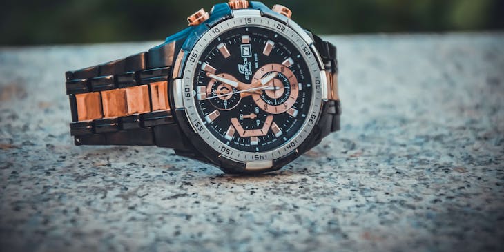 A close-up photo of a black wristwatch.