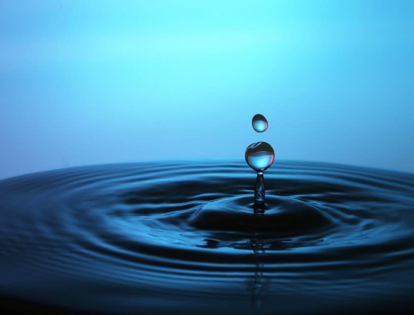 Ein Wassertropfen fällt in ein frisch aufbereitetes Trinkwasser.