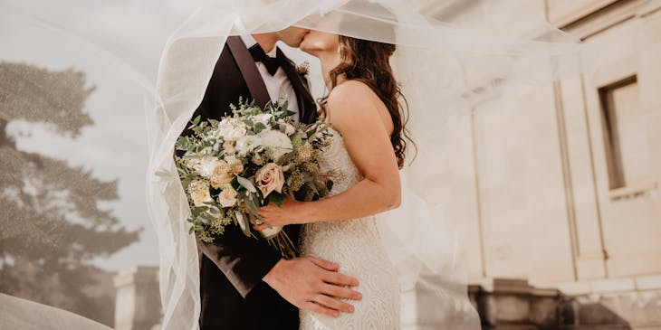 A bride and groom sharing a kiss.