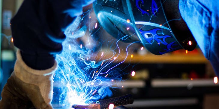 A person welding a steel frame.