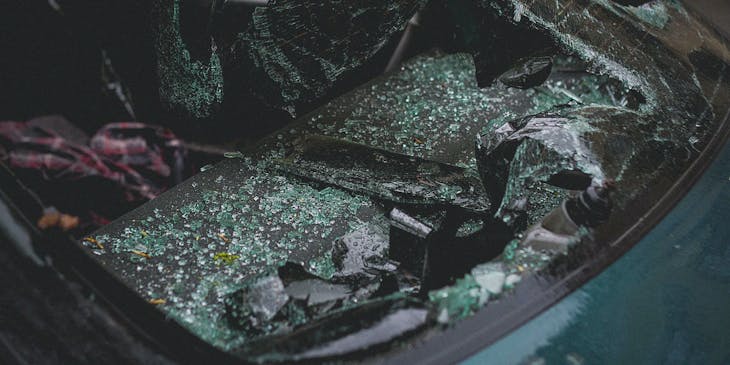 Close up of broken windshield that needs to be repaired.