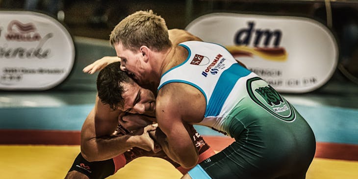 Two men competing in a wrestling match.