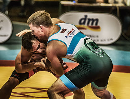 Two men competing in a wrestling match.