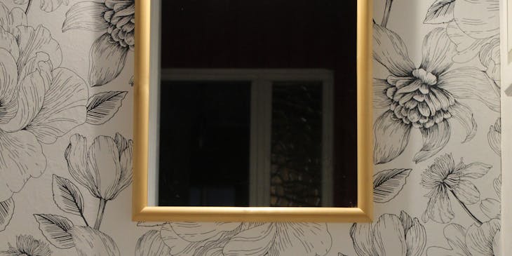 Striking wallpaper brightening a bathroom.